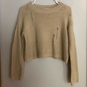 Cropped, distressed sweater